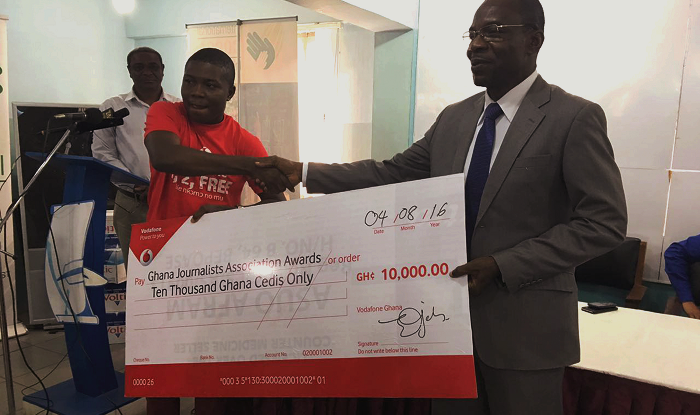 Mr Ebenezer Amankwah (left) presenting a dummy cheque to Mr Affail Monney (right).